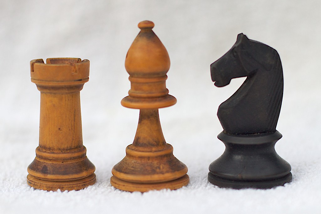 Knight chess pieces on a wooden board