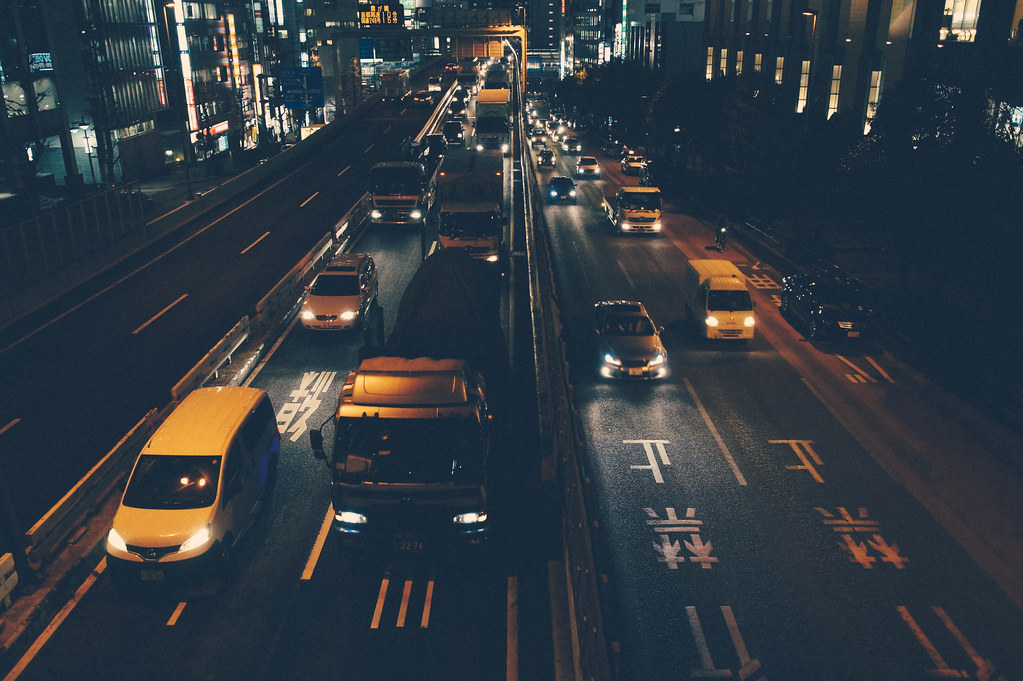 Delivery trucks at a warehouse at night