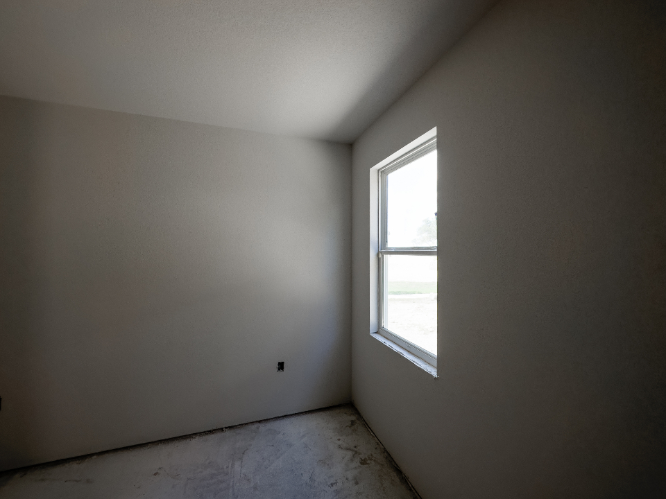 Empty room with bare drywall during buildout