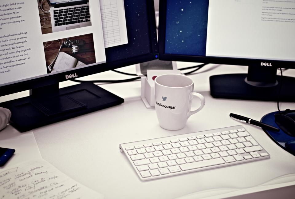 Dual-monitor workstation on an office desk