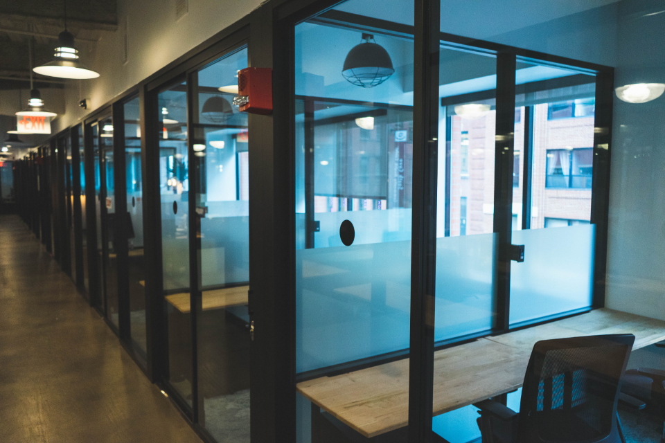 Modern glass-walled office at dusk