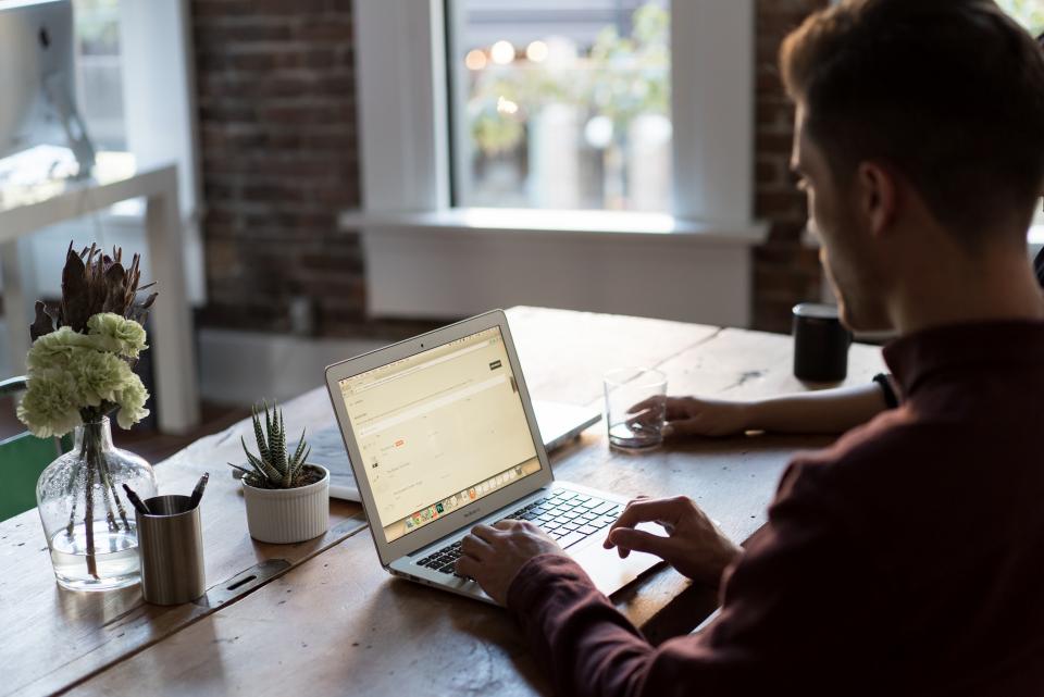 Person working at a laptop by a window