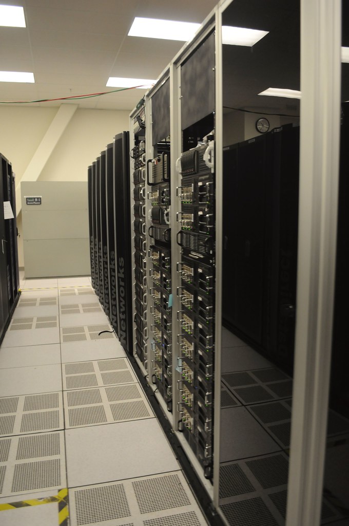 Rows of server racks in a telecom data center