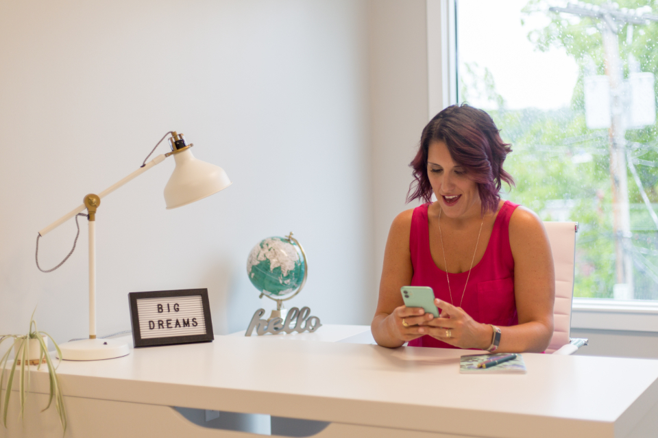 Person at a desk looking at their phone