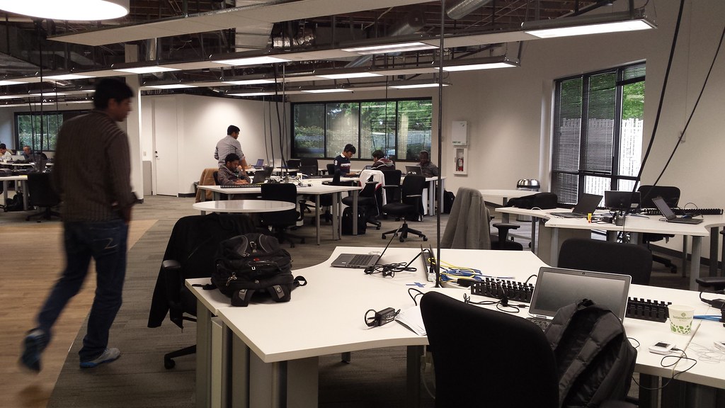 Person walking through a contemporary open-plan office