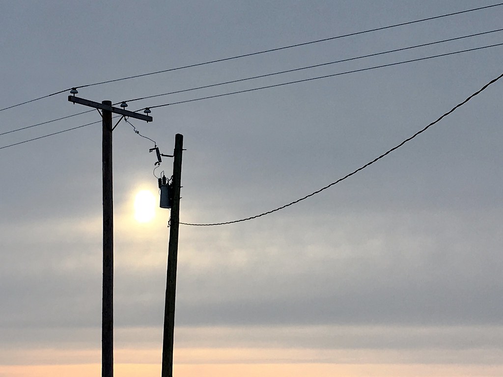 Telephone lines and poles at dusk