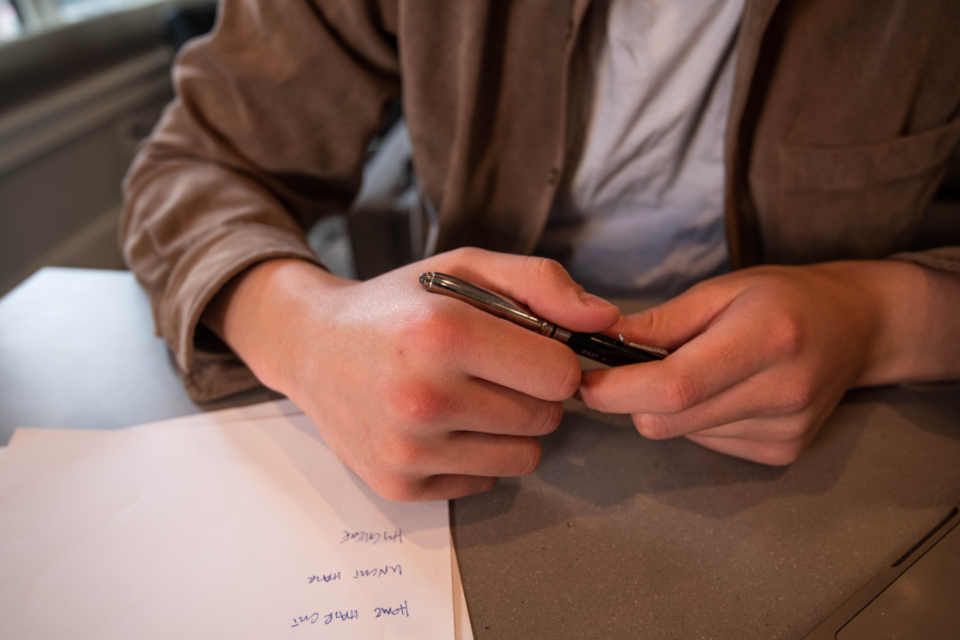 Hands sorting paperwork on an office desk