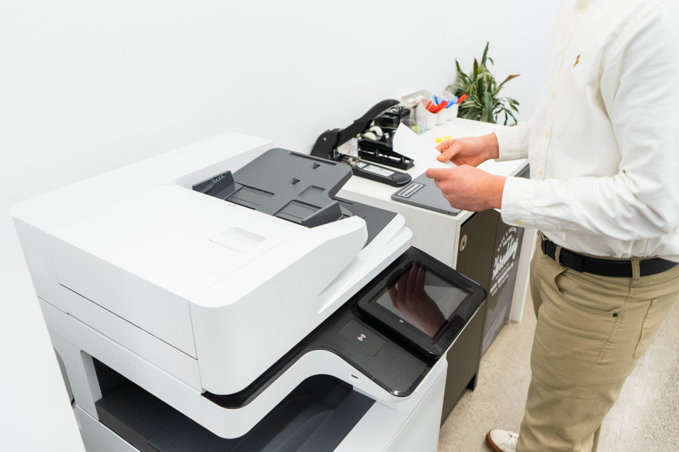 Person using an office printer and fax machine