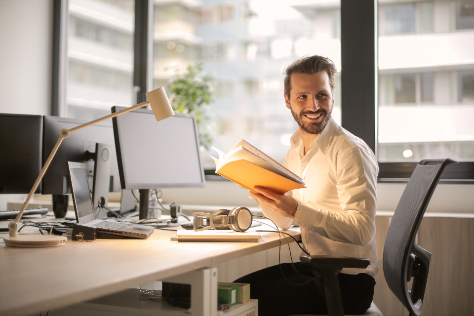 Smiling person at an office computer