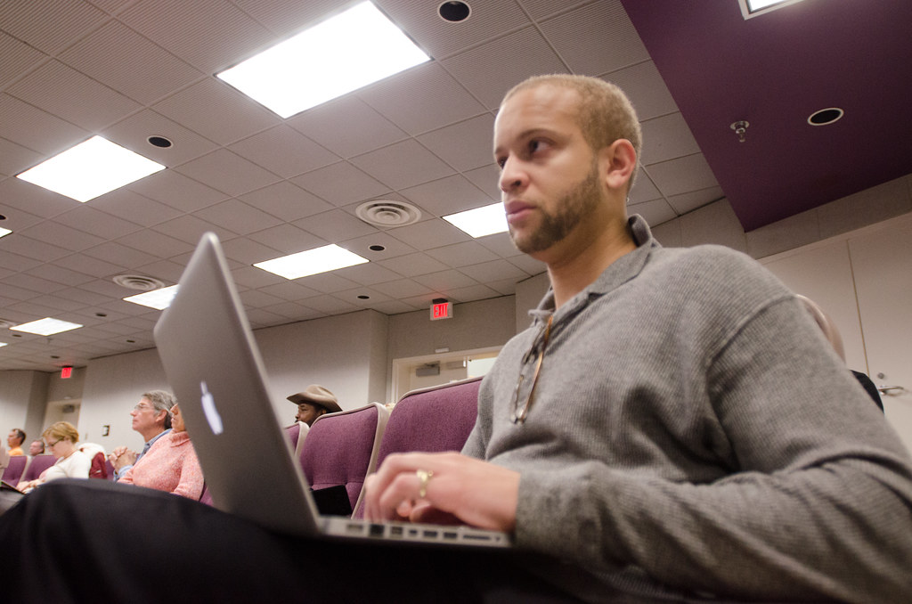 Attendee with a laptop in a training seminar
