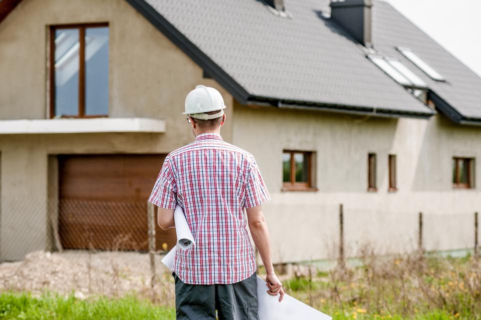 Contractors reviewing construction plans on site