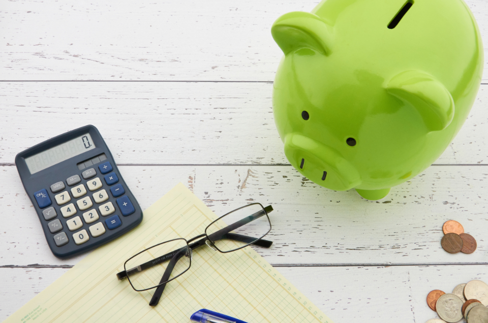 Piggy bank and calculator representing cost avoided
