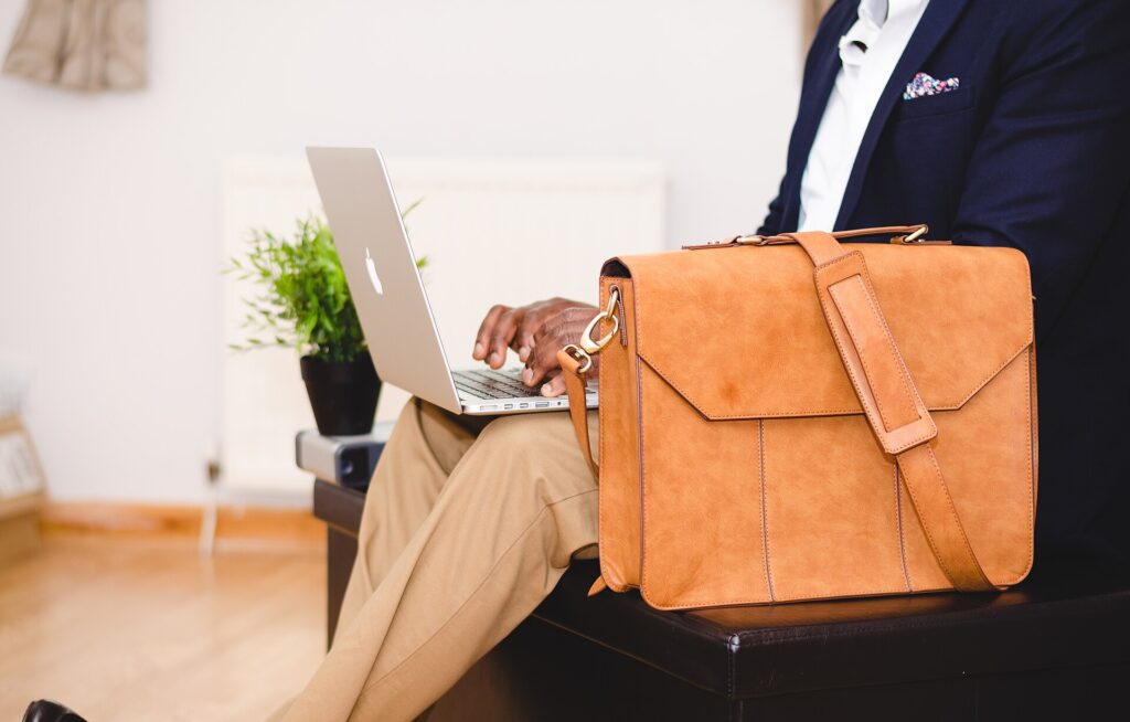 Businessman typing on a laptop (Unsplash)