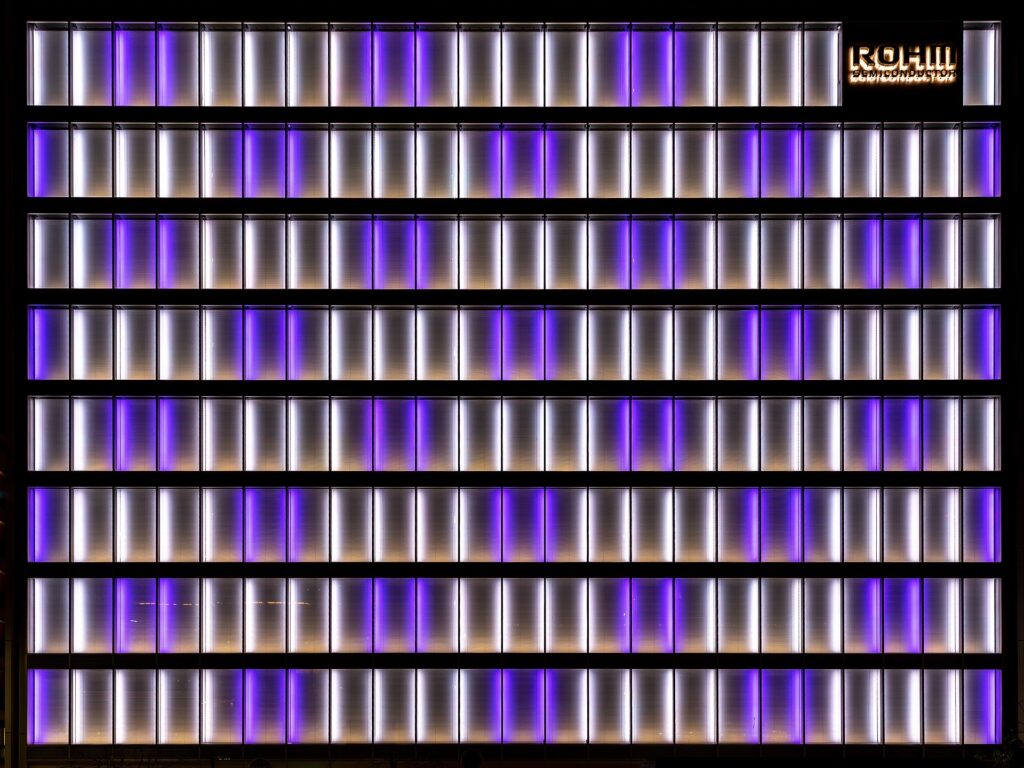 Illuminated white and purple facade of the office building Rohm Semiconductor in Kyoto, Japan