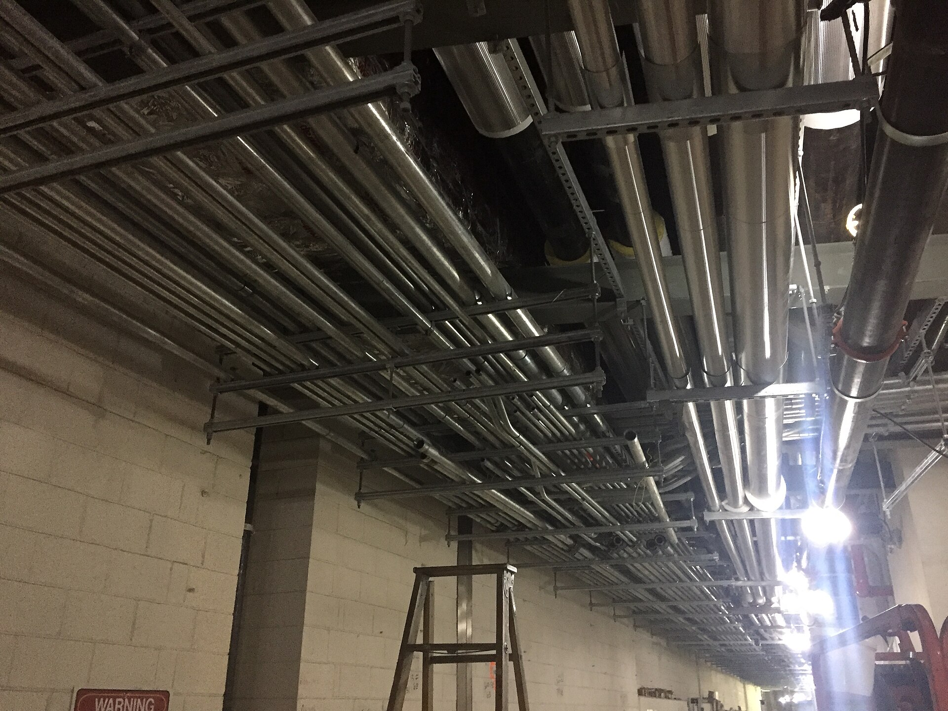 Continued installation of overhead electrical conduit through the east service corridor of the future LIRR concourse. (C