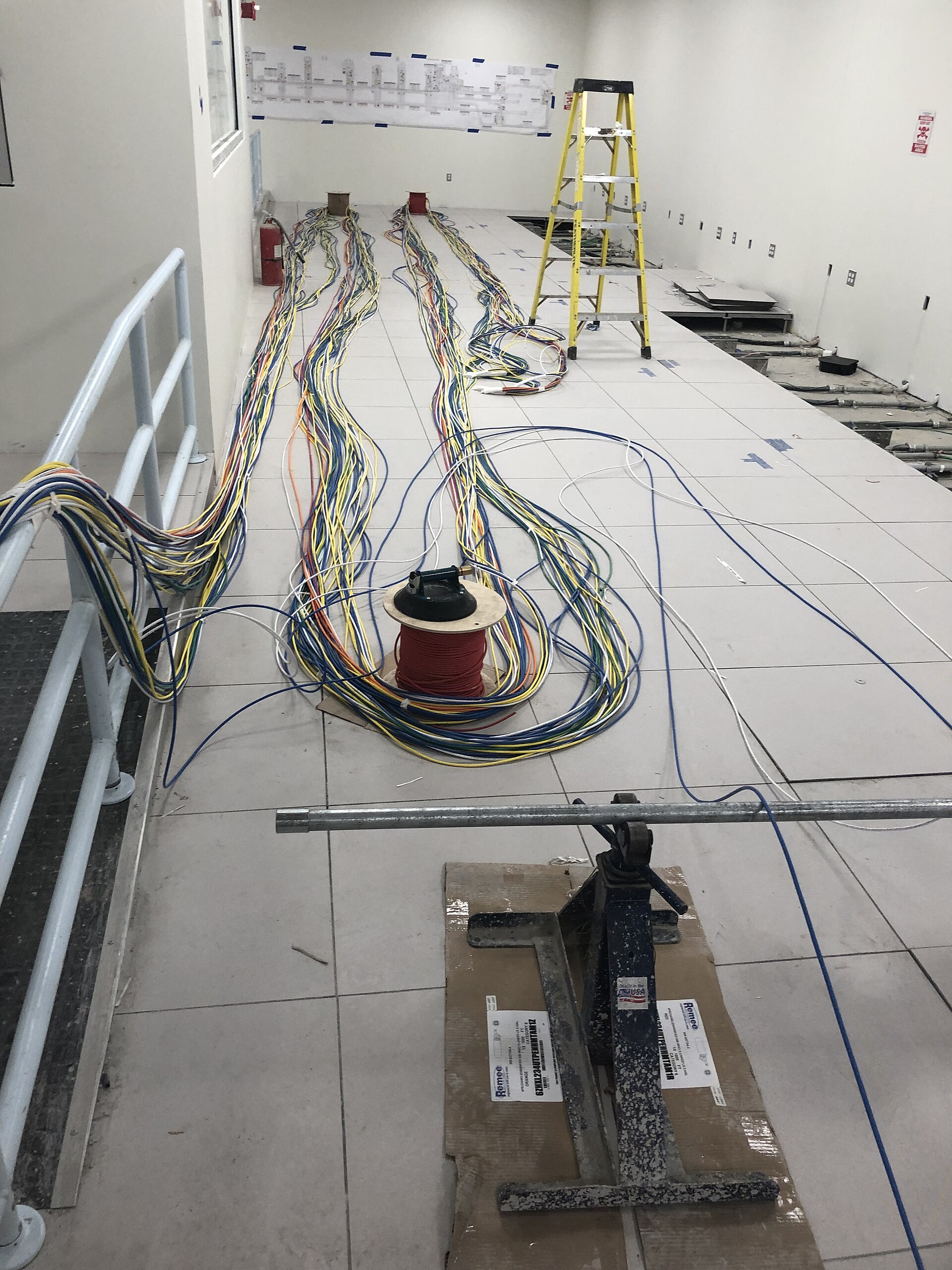 Data cables prepped for installation under the floor of the Train Operation Center. (CS179, 08-14-2019) (48552632251)