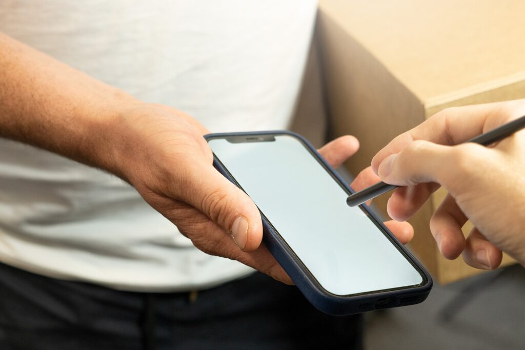 Signing for a parcel delivery on a phone