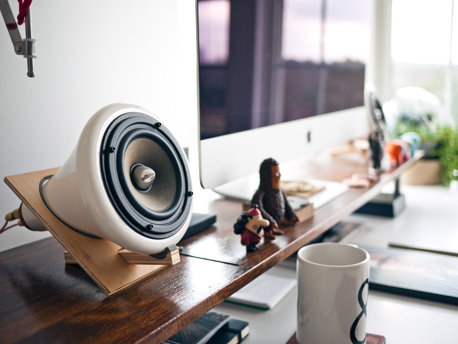 Office desk with computer and music player (Unsplash)