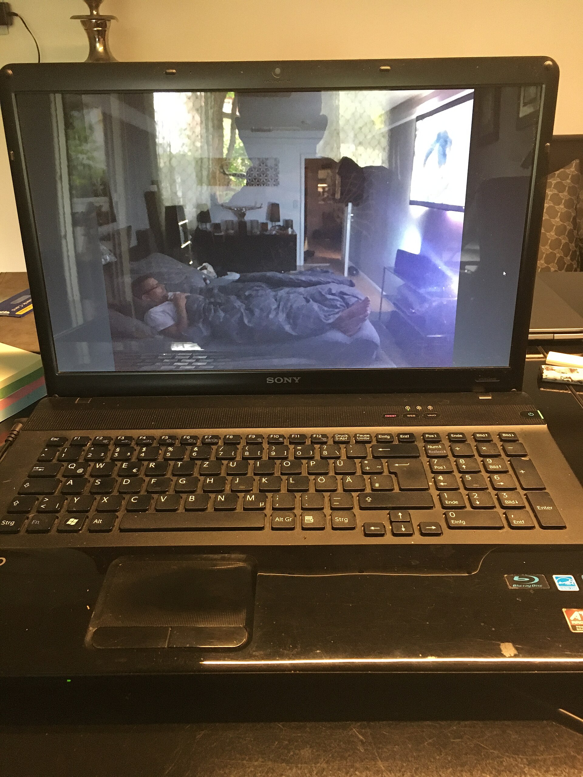 Sony Vaio Laptop showing video with man lying in bed watching TV
