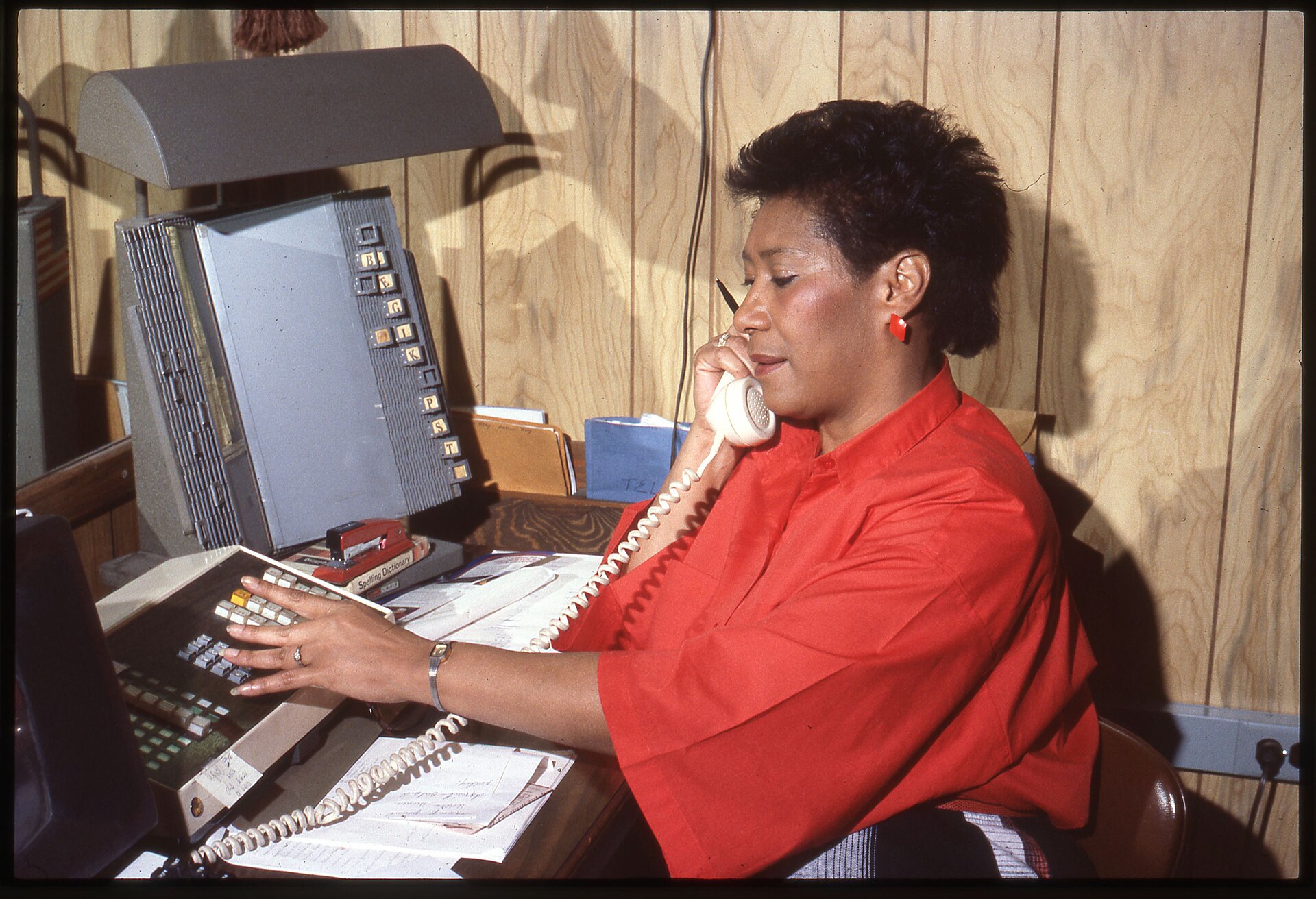 Unidentified female office worker using a telephone switchboard - DPLA - b9e94ce60c35a44f638c1a4fcbe38103