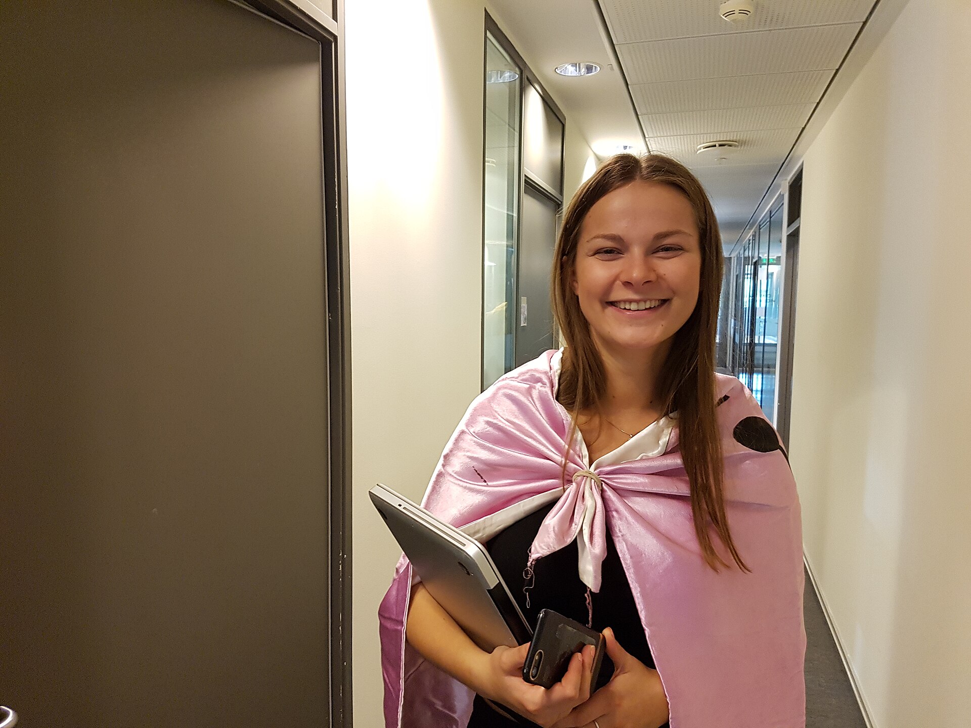Smiling woman holding laptop