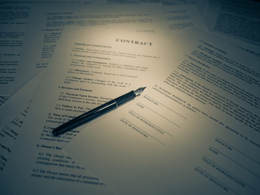 Printed contract with a pen for signing