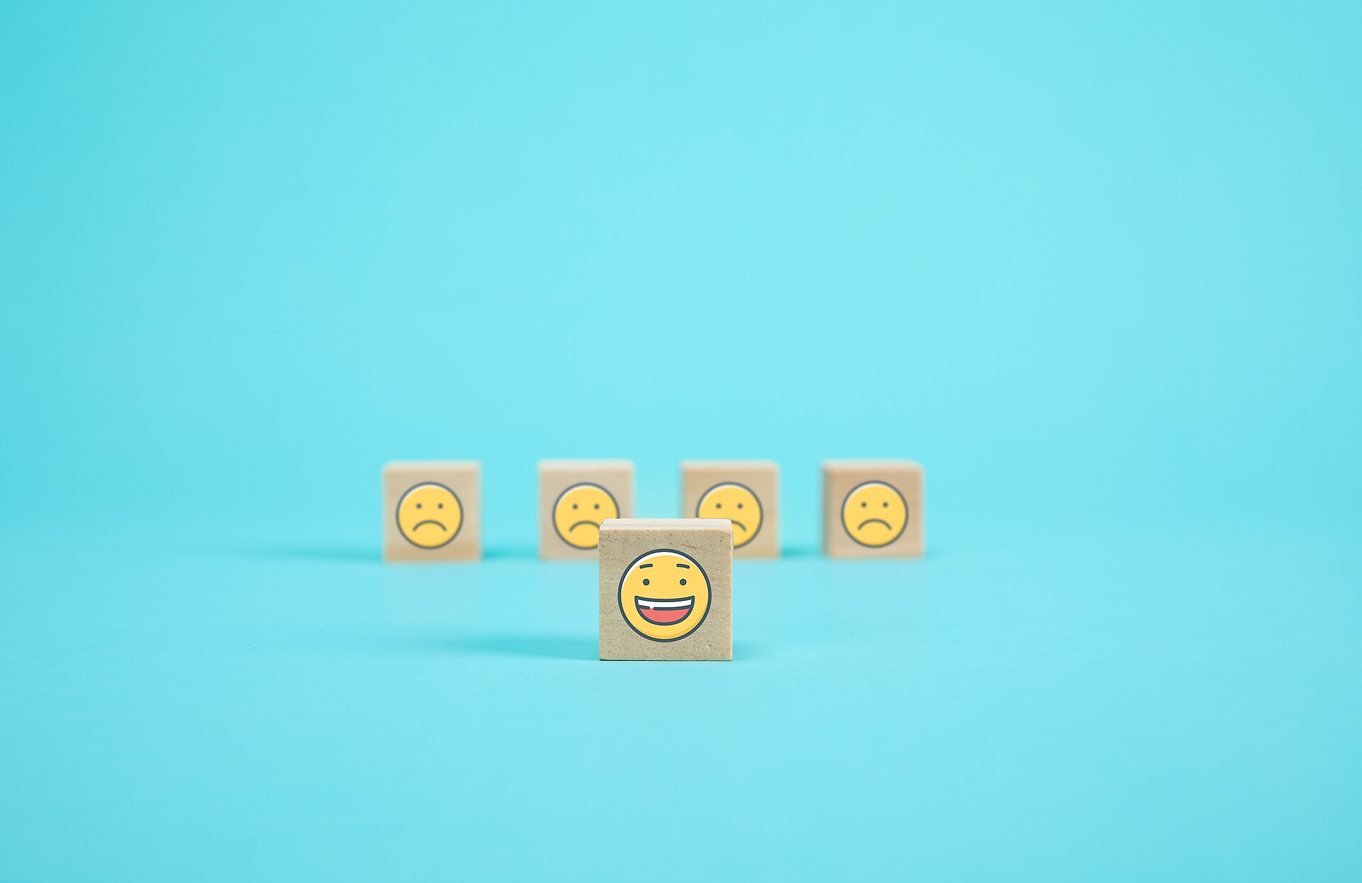 Wooden blocks showing a satisfaction rating scale