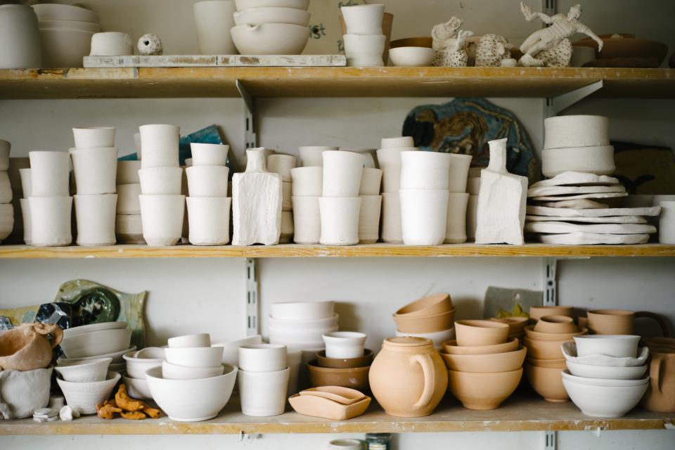 Shelves of handmade ceramics in an artisan maker's studio