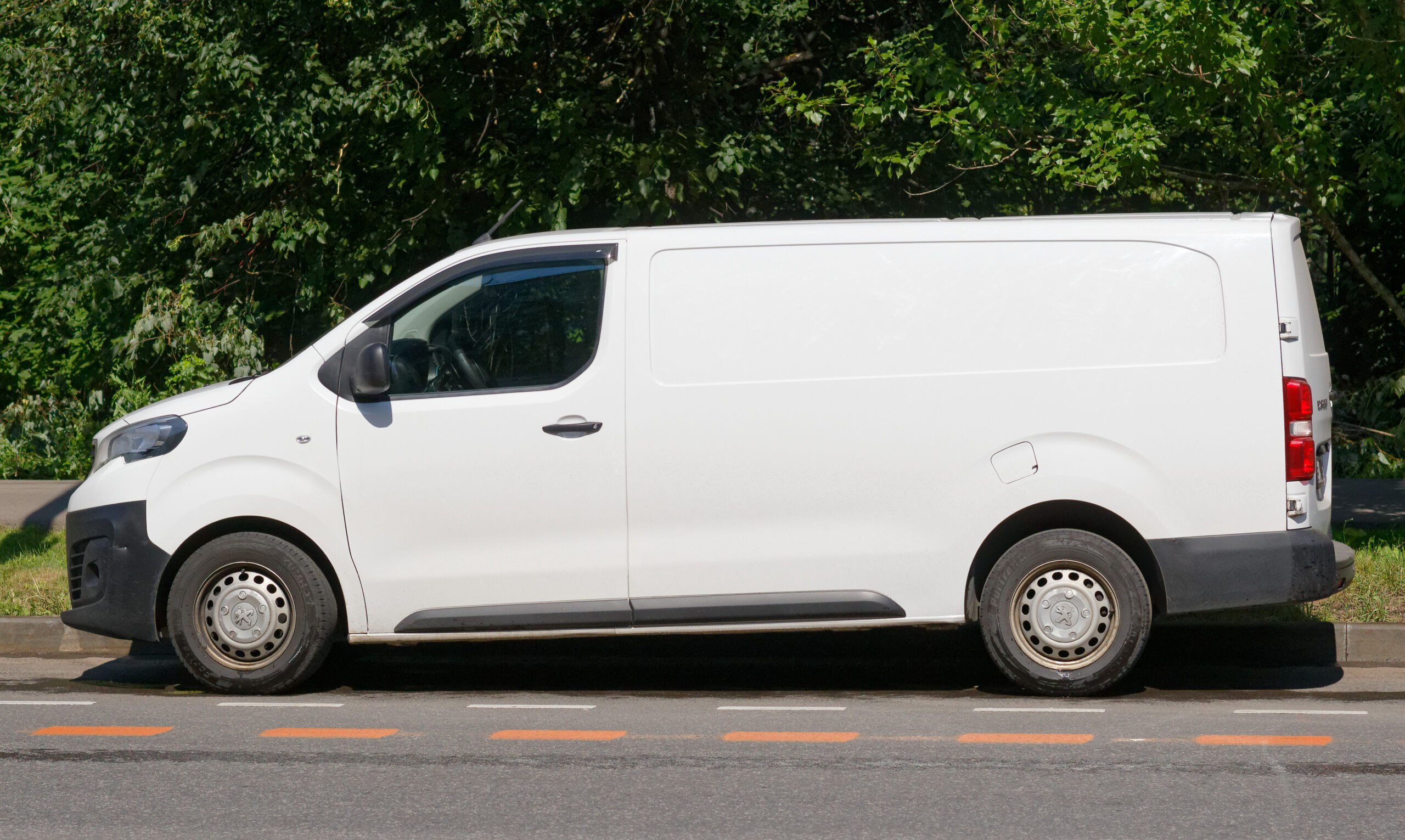 White unbranded cargo van parked on a city street
