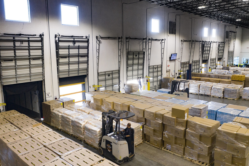 Forklift moving pallets inside a modern distribution center