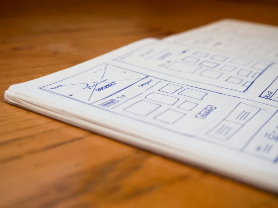 Hand-drawn website wireframe in a notebook