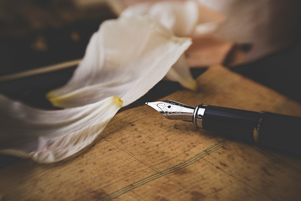 A fountain pen resting on aged paper