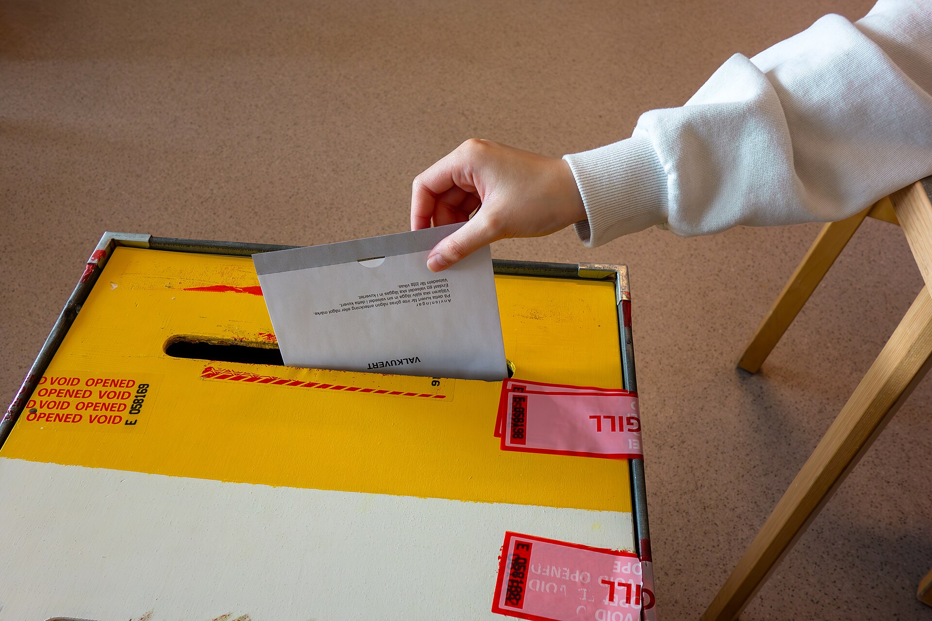 A voter casting a ballot into a ballot box